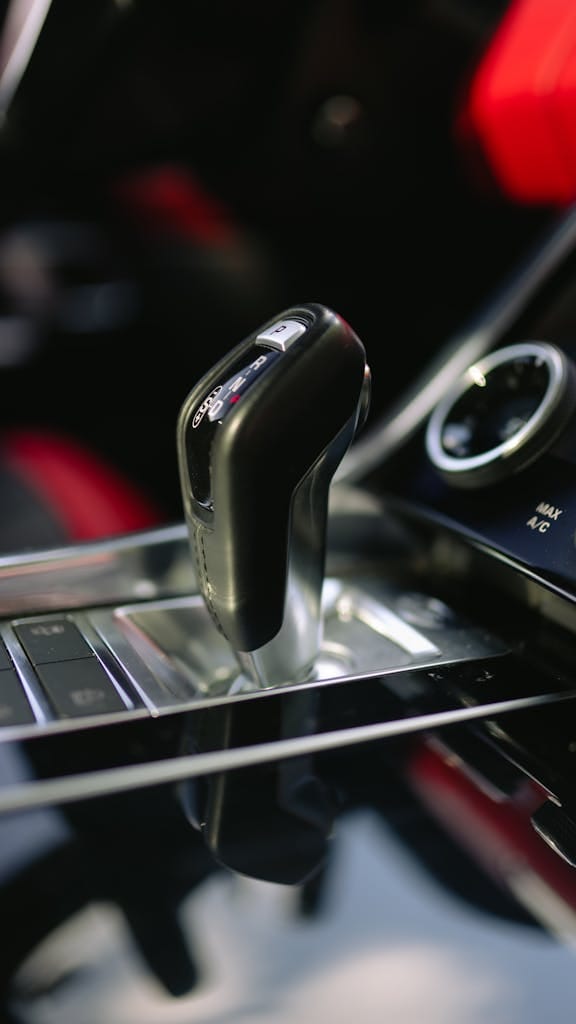 Detailed view of a luxury car gear shift, highlighting the design and interior elegance.