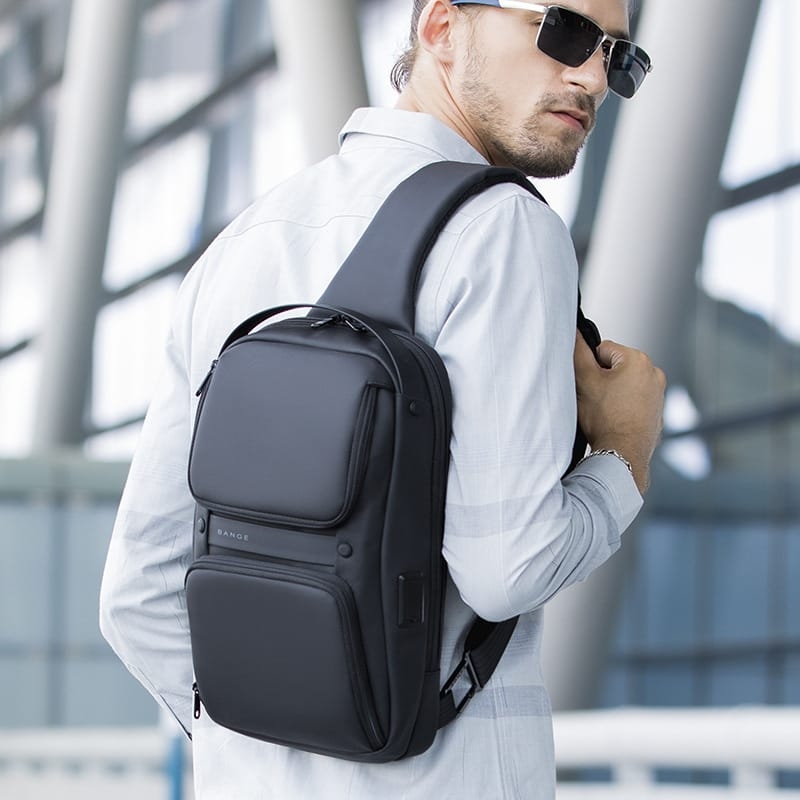 Young man carrying UrbanFlex Waterproof Sling Bag in sunny weather